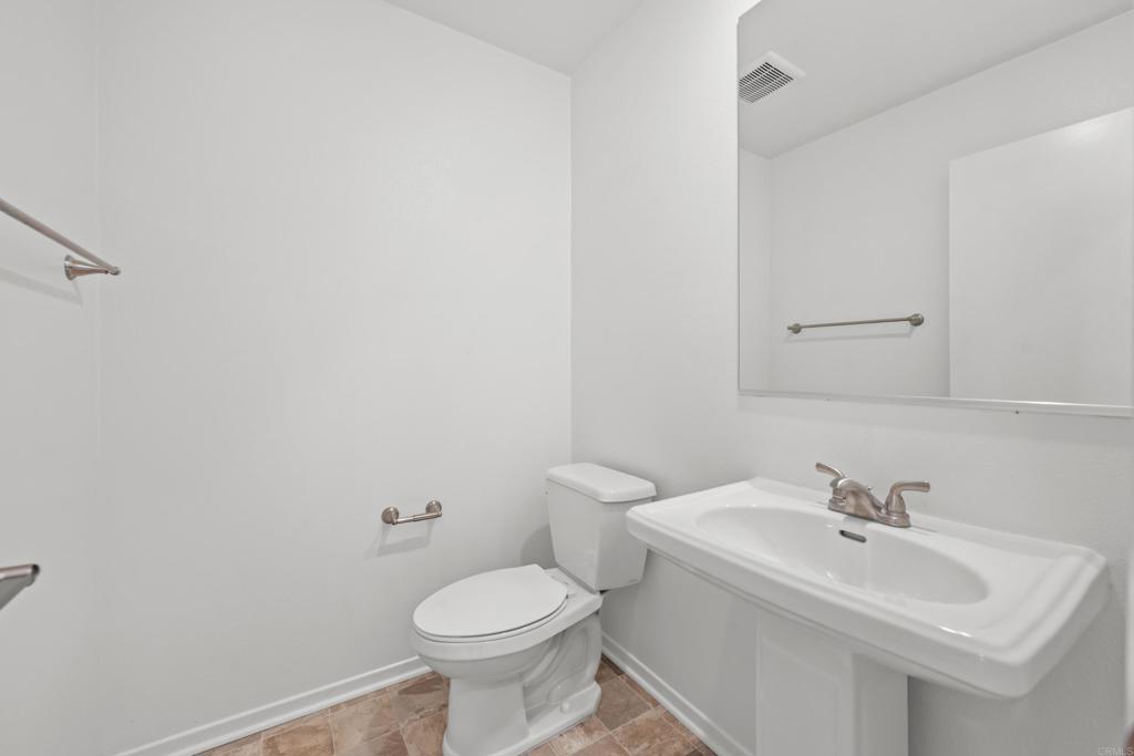 34742 Criollo Way Fallbrook, CA 92028 - Photo 4 of 28 a bathroom with a sink a toilet and mirror