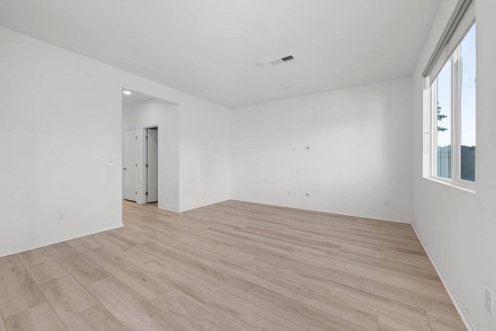 34742 Criollo Way Fallbrook, CA 92028 - Photo 6 of 28 a view of an empty room with wooden floor and a window