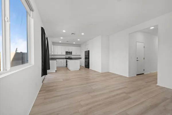 a view of a kitchen with a sink and a refrigerator