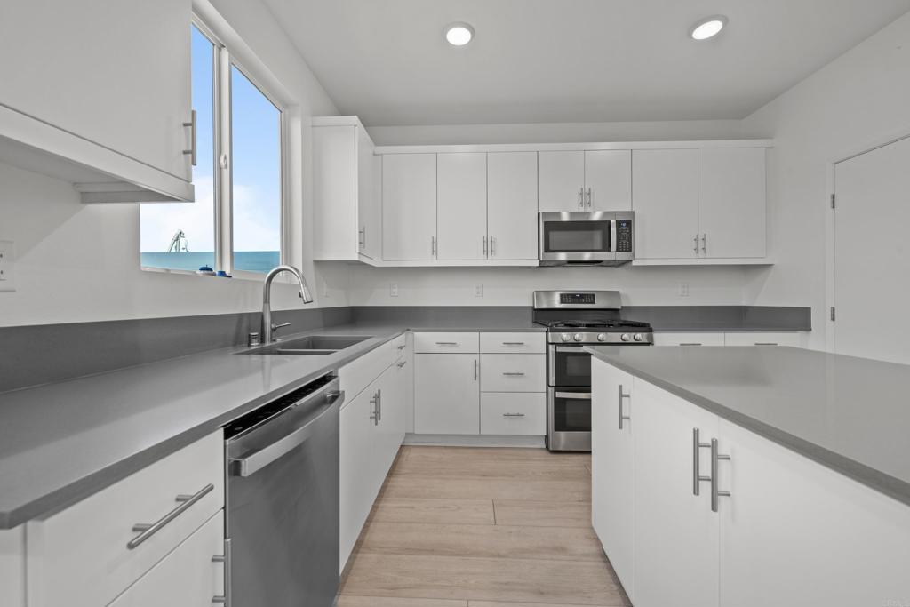 34742 Criollo Way Fallbrook, CA 92028 - Photo 10 of 28 a kitchen with cabinets appliances a sink and a counter top space