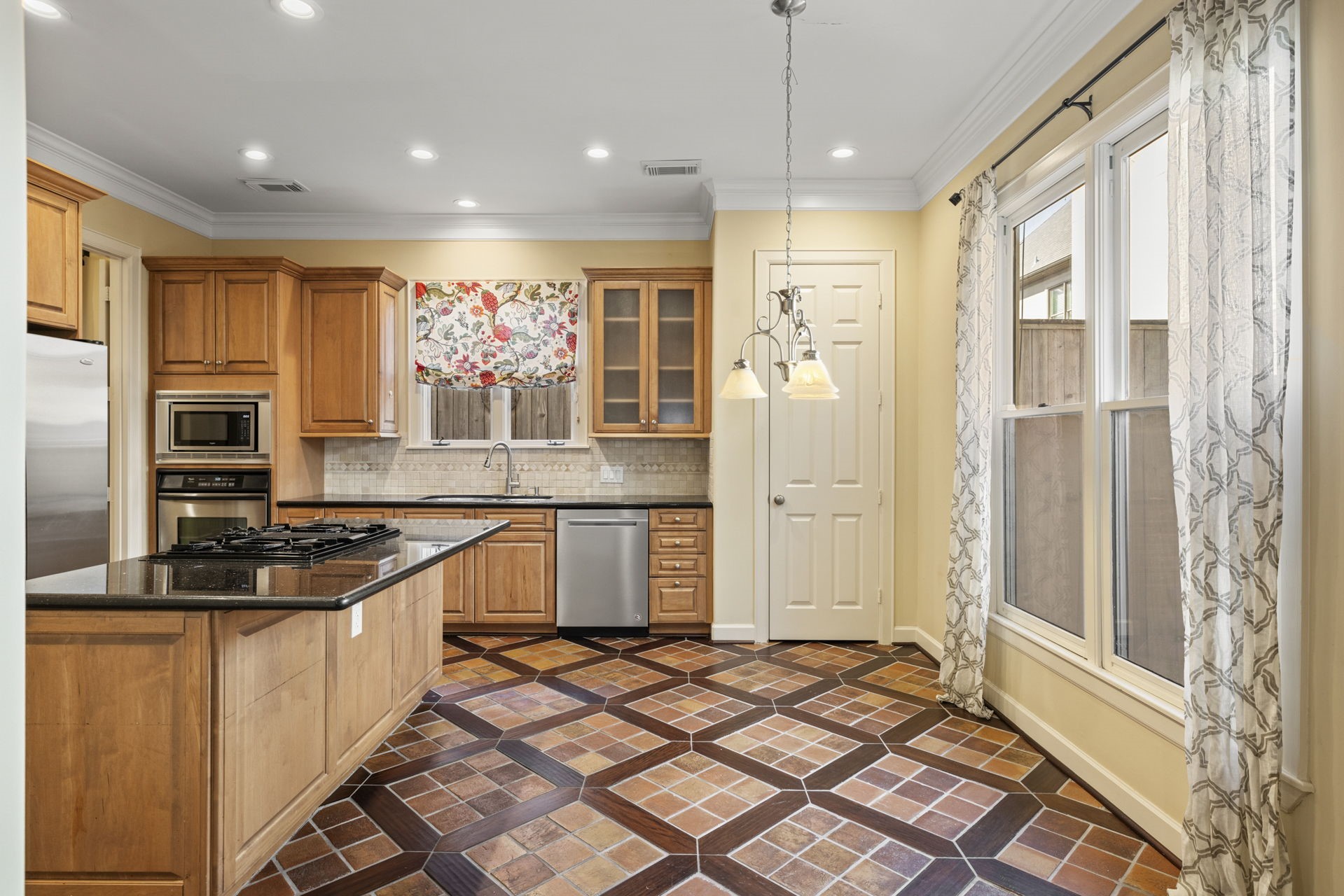 6310 Hermann Lake Drive Houston, TX 77021 - Photo 9 of 39 View of the kitchen and breakfast room with stunning wood and tile inlay flooring.