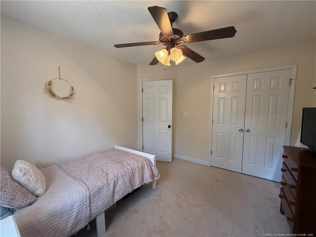 234 Pender Road Spring Lake, NC 28390 - Photo 36 of 39 a bedroom with a bed and a chandelier