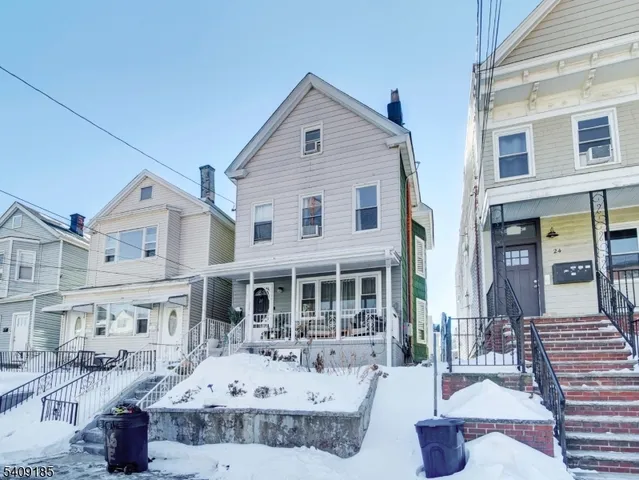 a front view of a house with sitting area
