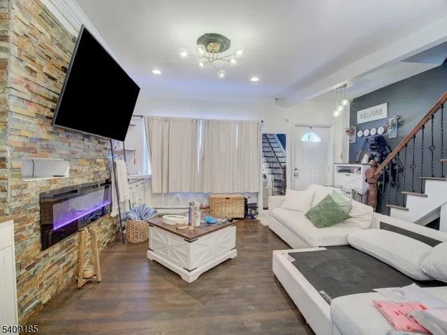 a living room with fireplace furniture and a flat screen tv