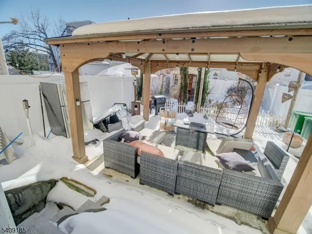 a view of living room filled with furniture and a fireplace