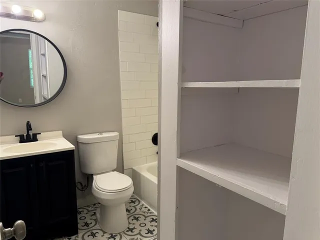 a bathroom with a toilet a sink and a mirror