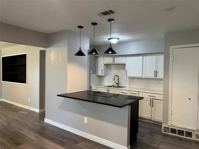 a kitchen with a sink a stove and cabinets
