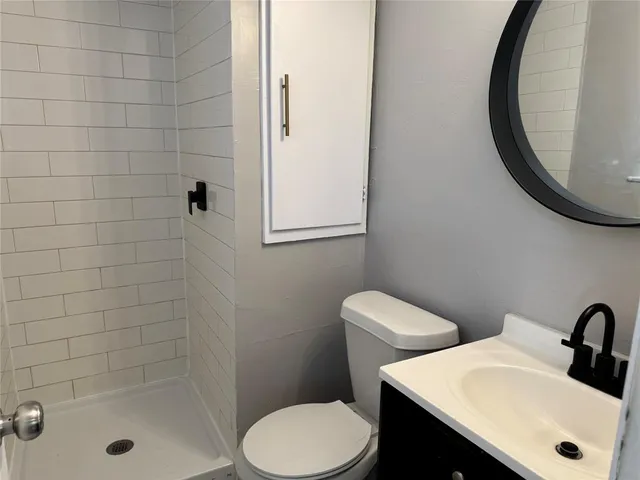 a bathroom with a sink a toilet and a mirror