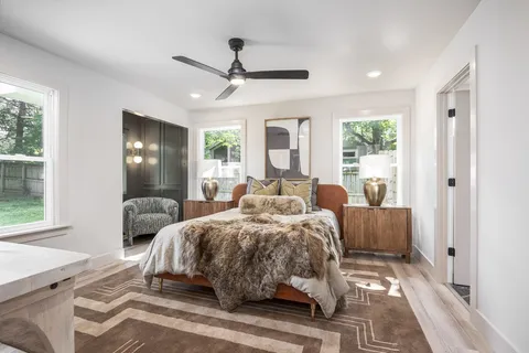 a bedroom with a bed and a mirror