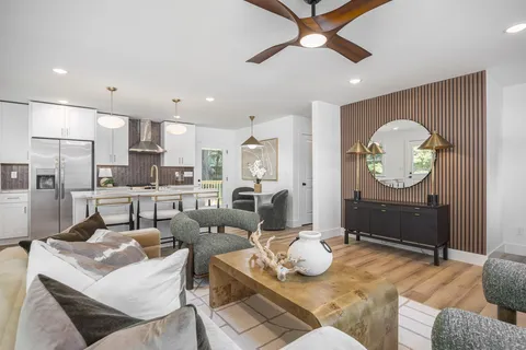 a living room with stainless steel appliances kitchen island granite countertop furniture and a view of kitchen
