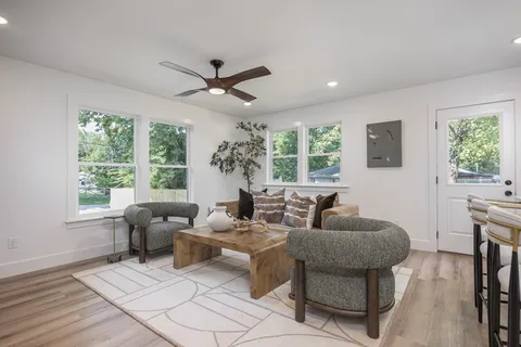 a living room with furniture and a large window