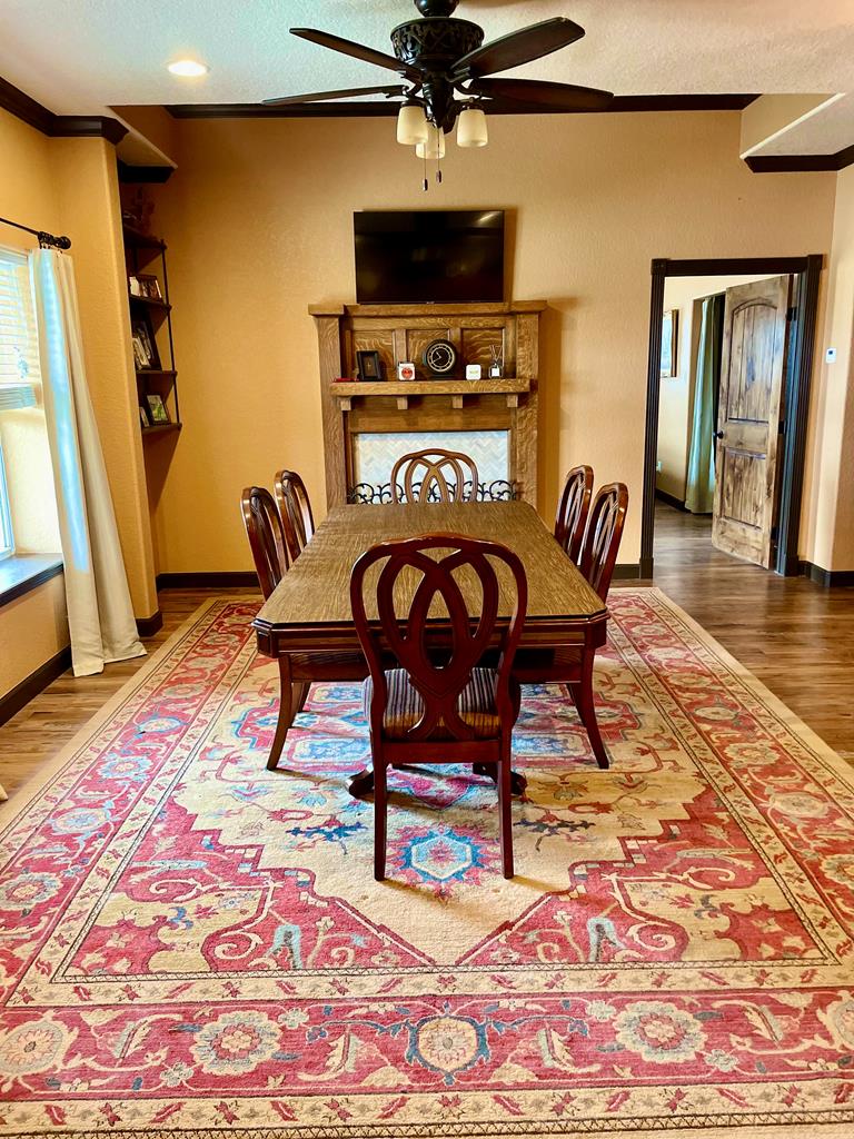 646 Victor Eckhardt Road Fredericksburg, TX 78624 - Photo 17 of 40 a view of a dining room with furniture and wooden floor