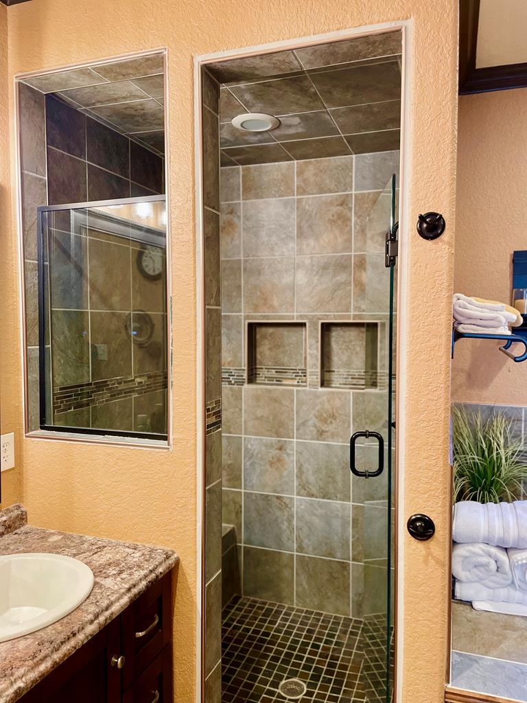 646 Victor Eckhardt Road Fredericksburg, TX 78624 - Photo 27 of 40 a bathroom with a granite countertop shower and a sink