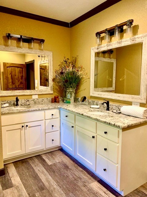 646 Victor Eckhardt Road Fredericksburg, TX 78624 - Photo 36 of 40 a spacious bathroom with a granite countertop sink and a mirror
