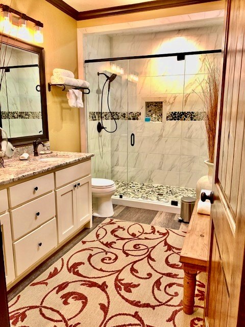 646 Victor Eckhardt Road Fredericksburg, TX 78624 - Photo 39 of 40 a bathroom with a sink a toilet and shower