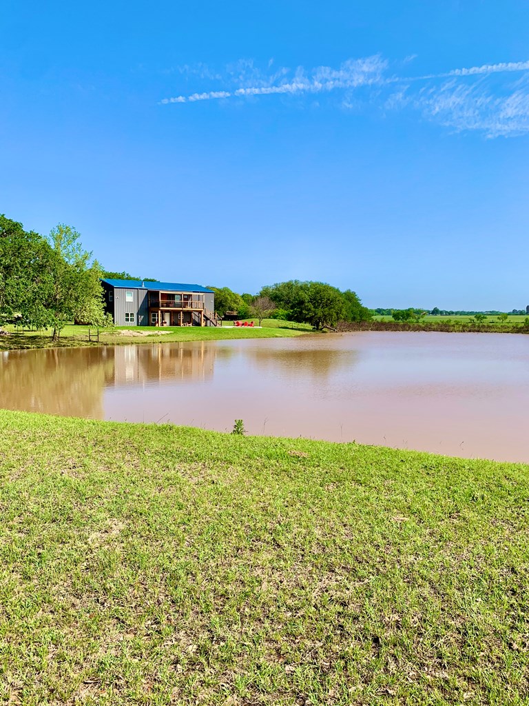 646 Victor Eckhardt Road Fredericksburg, TX 78624 - Photo 8 of 40 a view of a lake with houses in the back