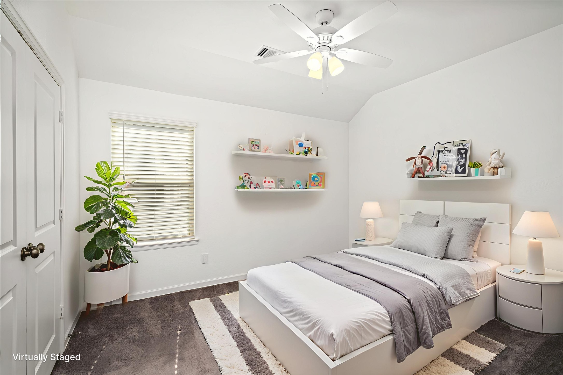 575 Dry Fork Lane Conroe, TX 77304 - Photo 19 of 34 Nice-sized secondary bedroom with ceiling fan, plush carpet, and soft natural light. Attached shelves are staged and do not convey.
