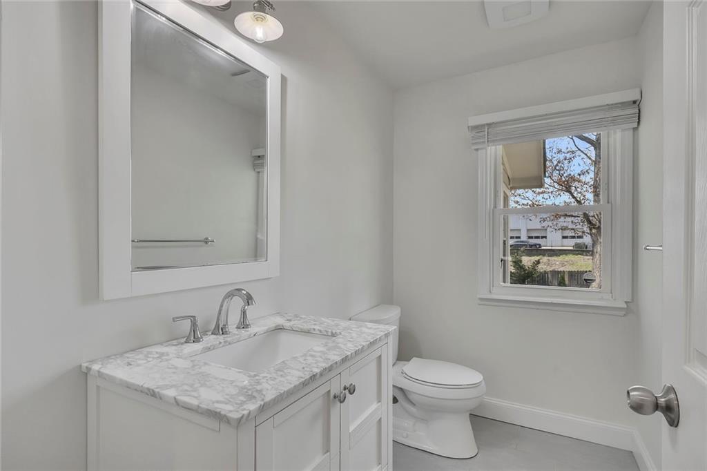3940 Forrest Court Chamblee, GA 30341 - Photo 18 of 35 a bathroom with a granite countertop sink toilet and a mirror