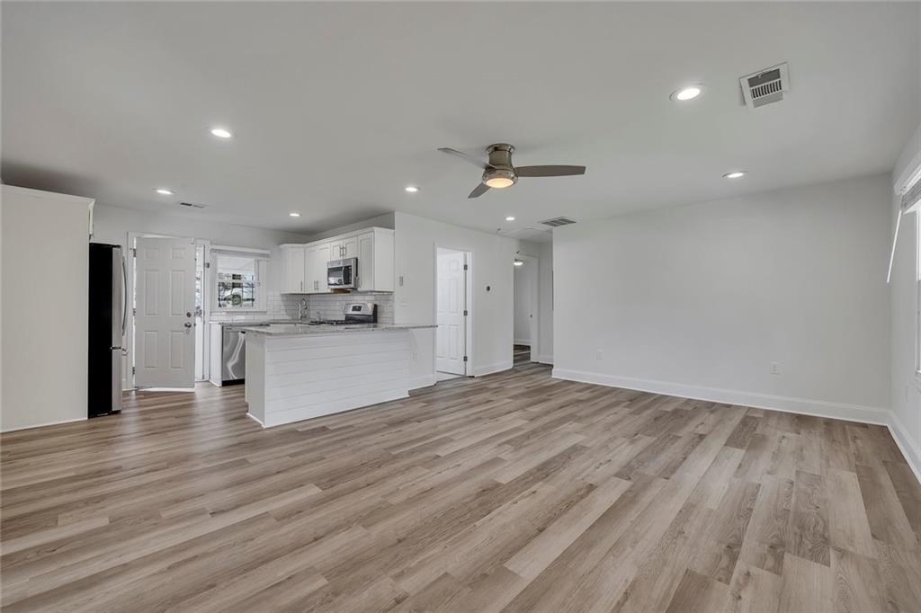 3940 Forrest Court Chamblee, GA 30341 - Photo 5 of 35 a view of kitchen dining room with wooden floor and refrigerator