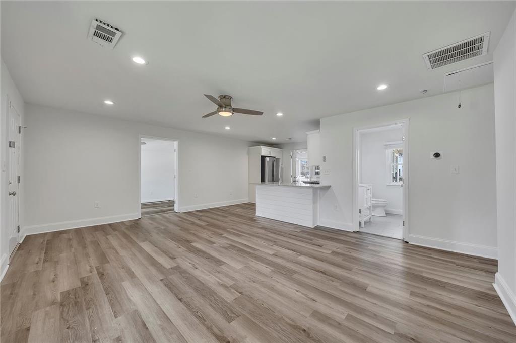 3940 Forrest Court Chamblee, GA 30341 - Photo 7 of 35 a view of empty room with wooden floor and windows