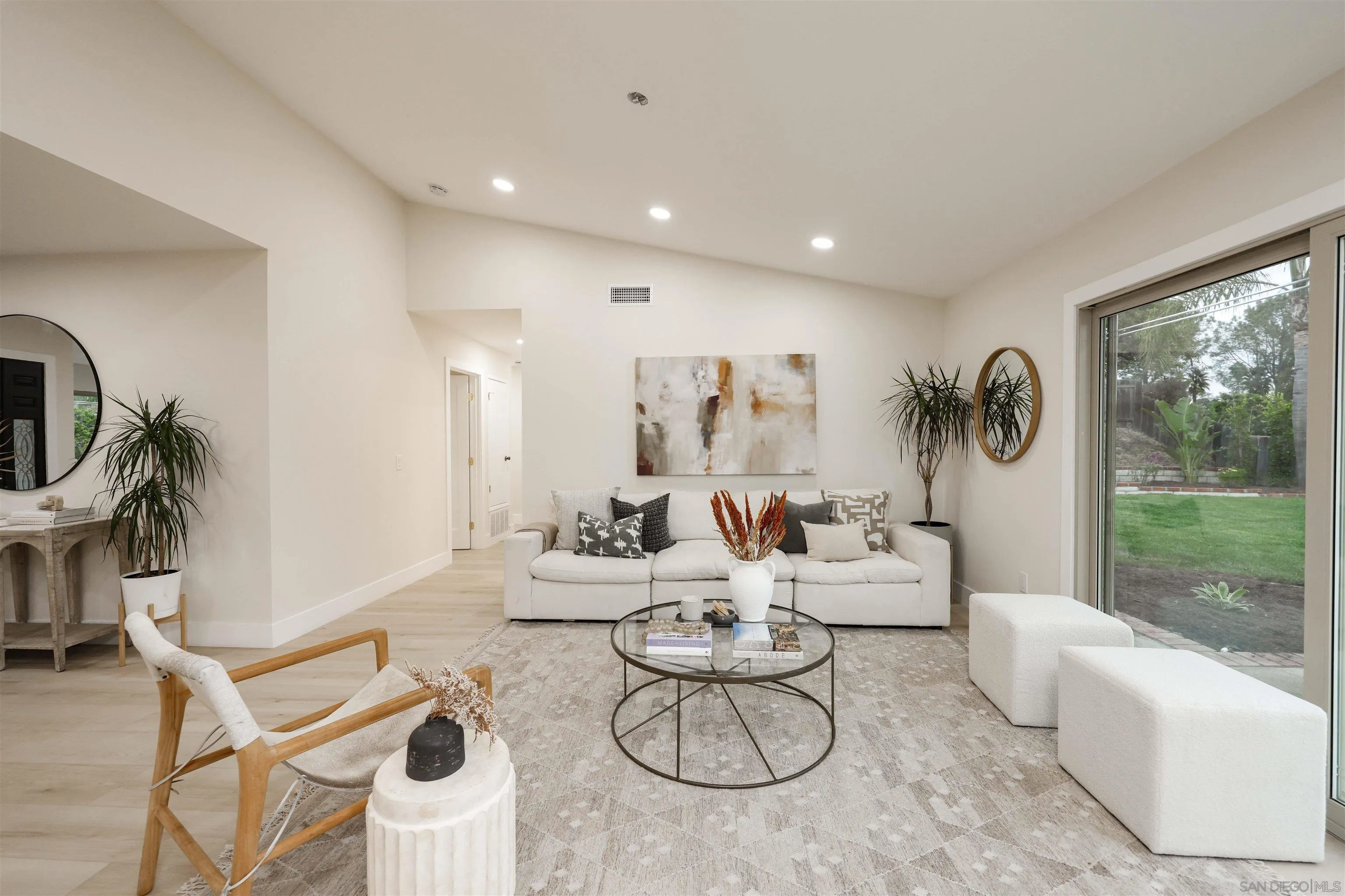 837 Elmview Drive Encinitas, CA 92024 - Photo 14 of 27 a living room with patio furniture and a floor to ceiling window