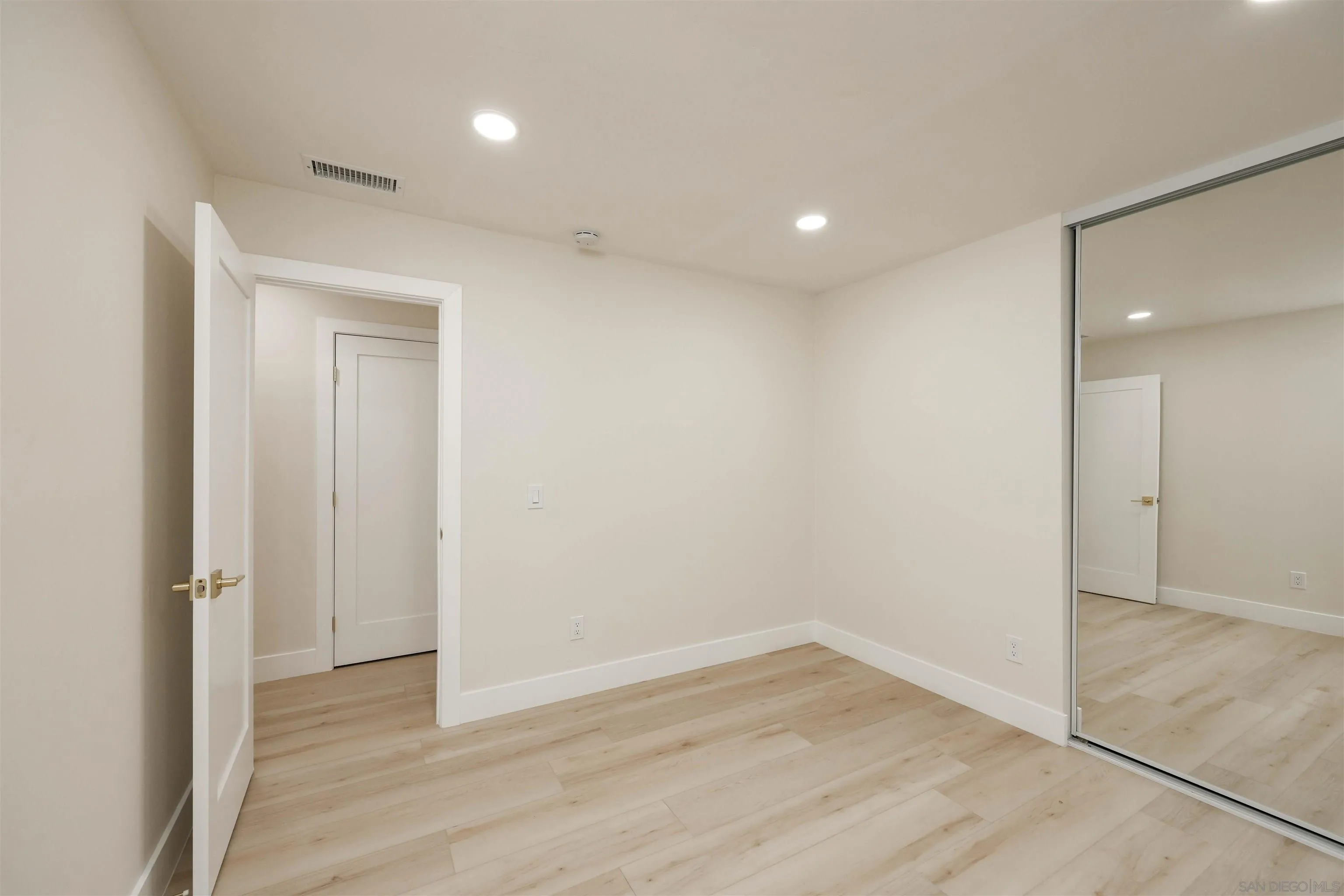 837 Elmview Drive Encinitas, CA 92024 - Photo 20 of 27 wooden floor in an empty room with a window