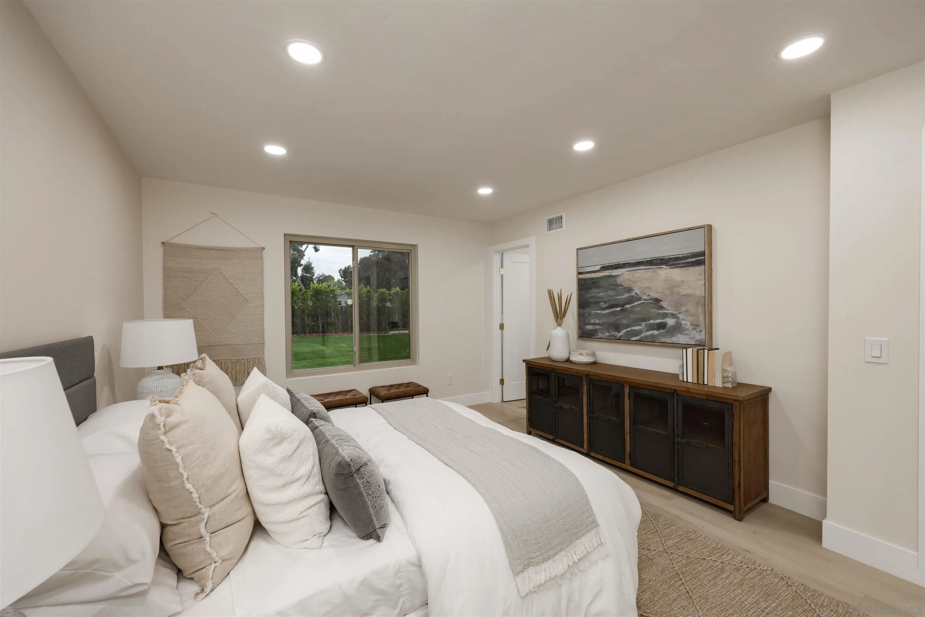 837 Elmview Drive Encinitas, CA 92024 - Photo 21 of 27 a bedroom with a large bed and a window