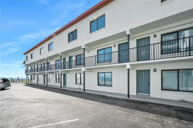 a front view of a house with yard and patio