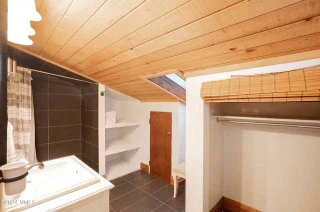 a view of walk in closet with empty racks