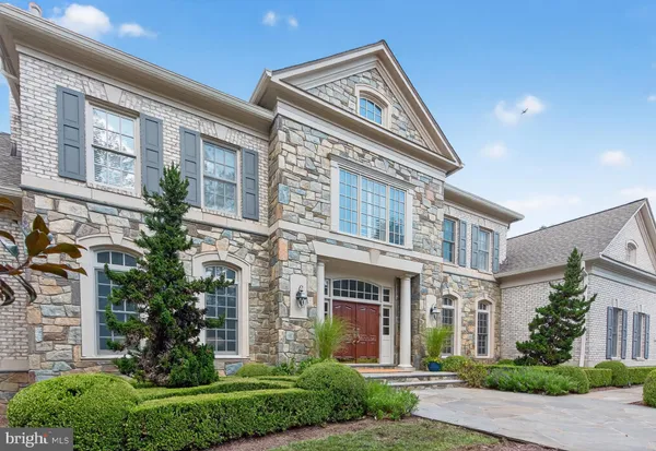 a spacious bedroom with a bed and large windows