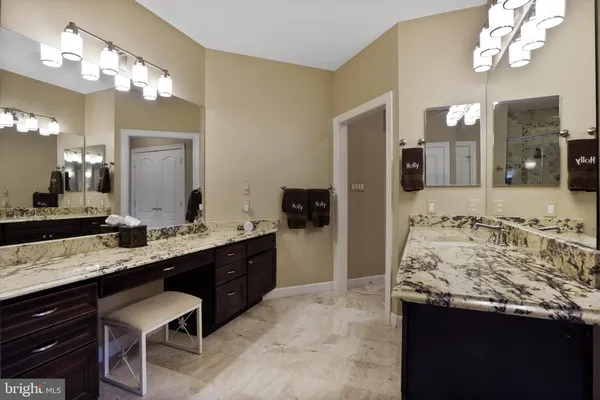 a living room with furniture a table and kitchen view