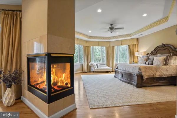 a living room with furniture a ceiling fan and a fireplace