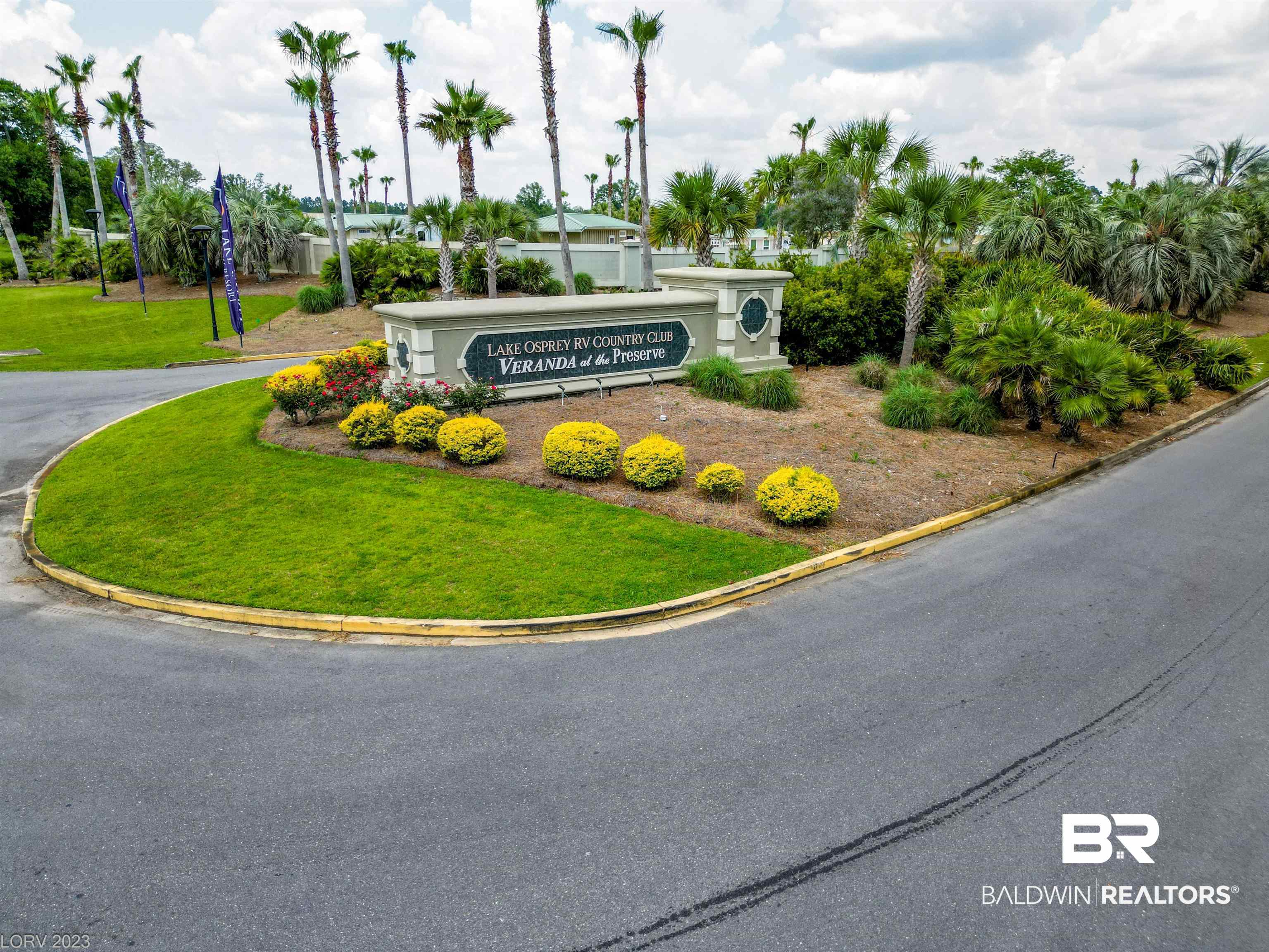 12489 Gateway Drive Elberta, AL 36530 - Photo 11 of 55 Community / neighborhood sign featuring a lawn