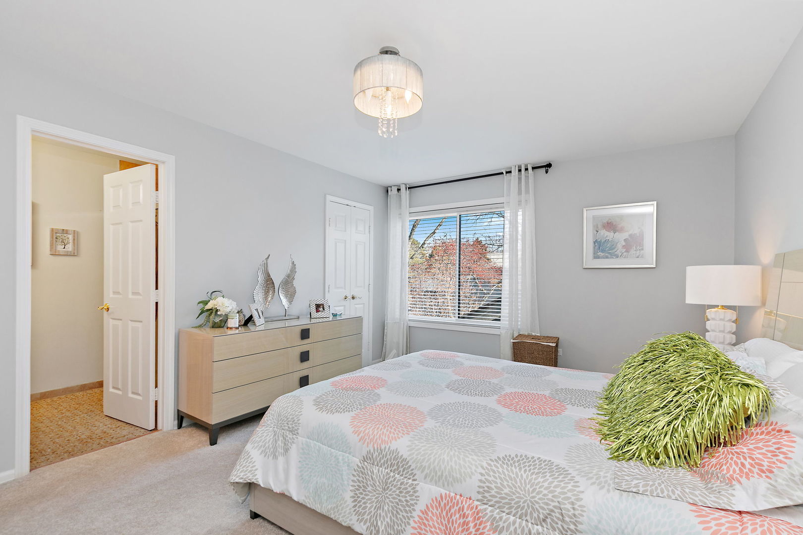 260 Timber Ridge Lane, Unit A Lake Barrington, IL 60010 - Photo 17 of 34 a bedroom with a bed and a chandelier