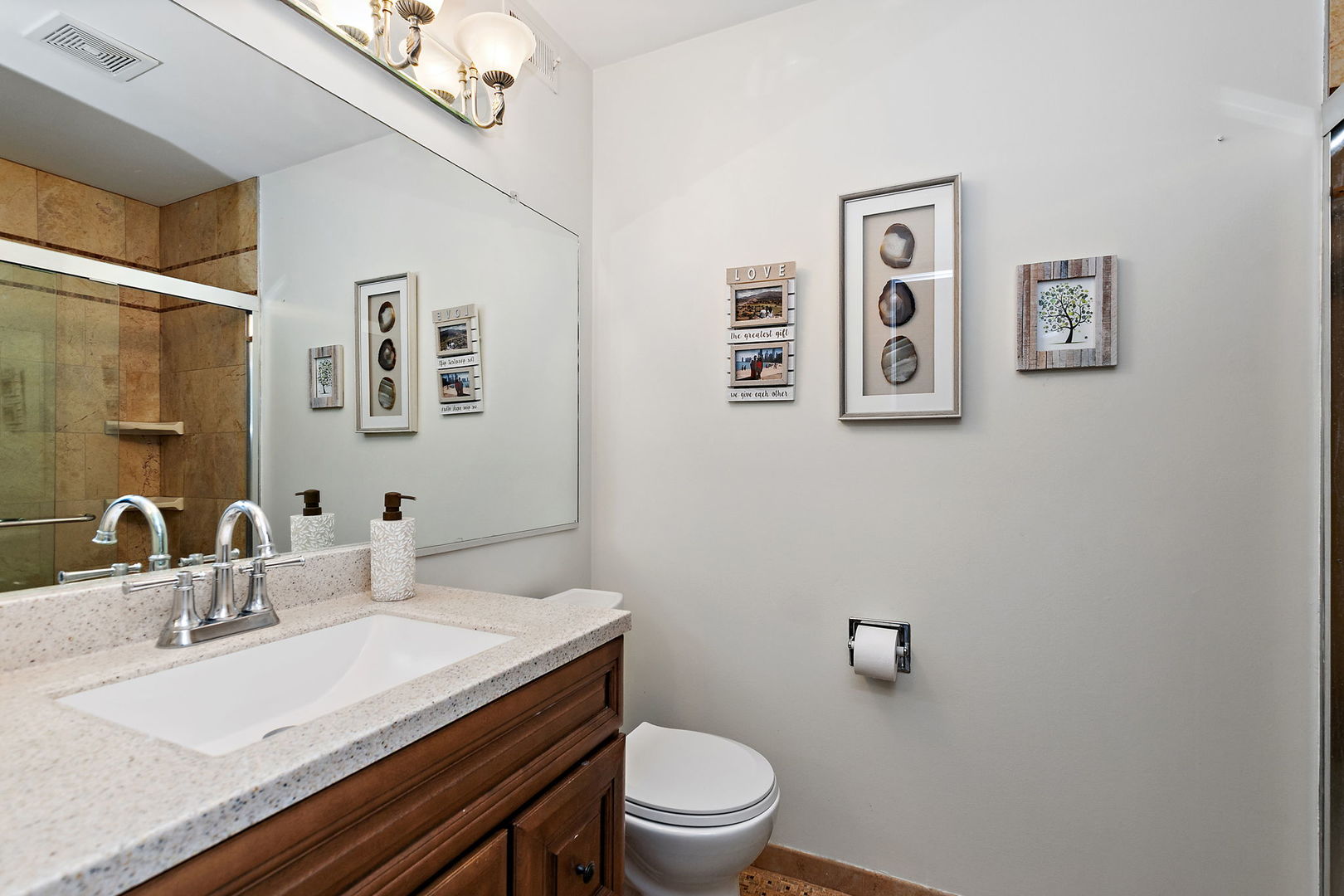 260 Timber Ridge Lane, Unit A Lake Barrington, IL 60010 - Photo 19 of 34 a bathroom with a granite countertop toilet sink and mirror