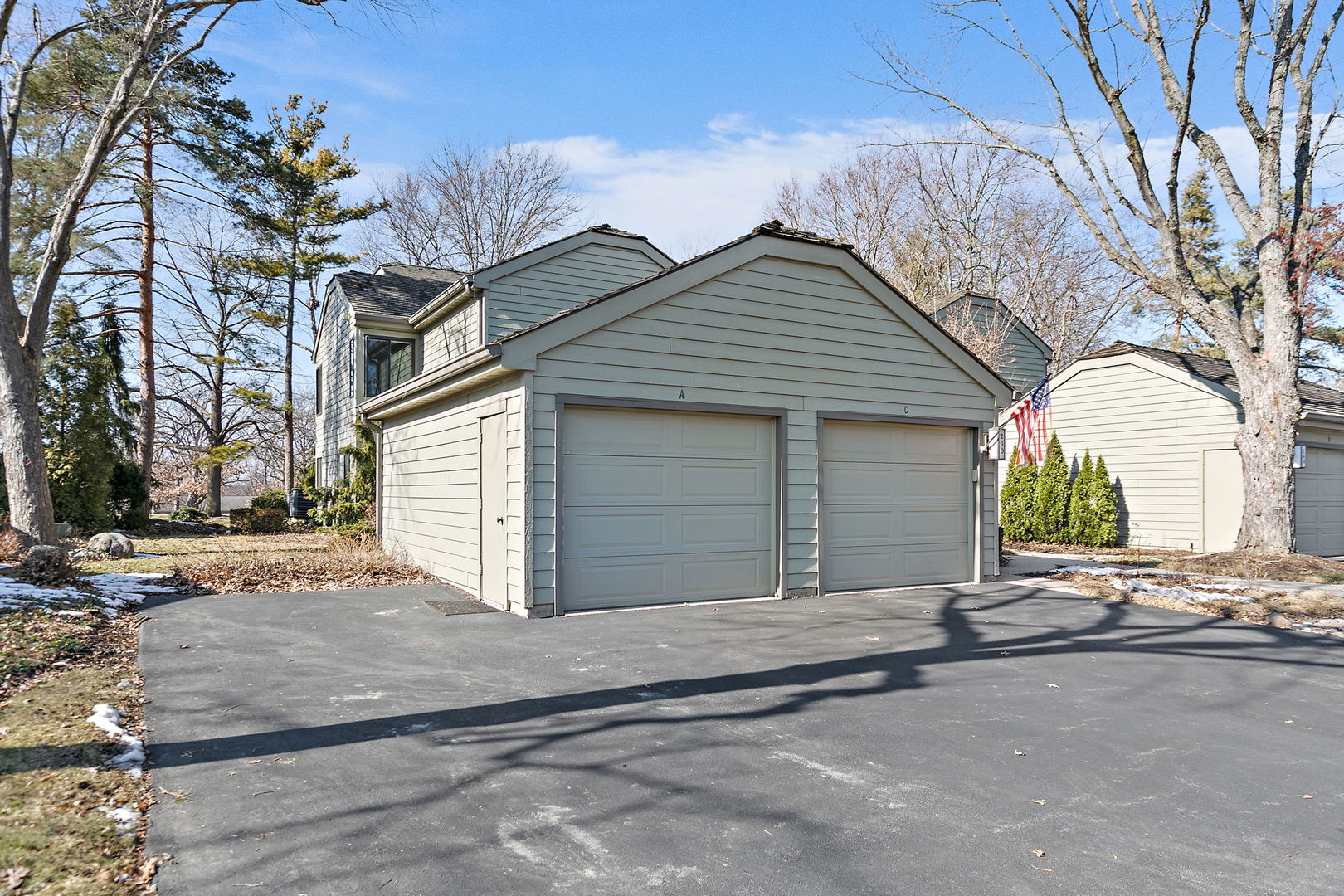 260 Timber Ridge Lane, Unit A Lake Barrington, IL 60010 - Photo 25 of 34 a front view of a house with a yard and garage