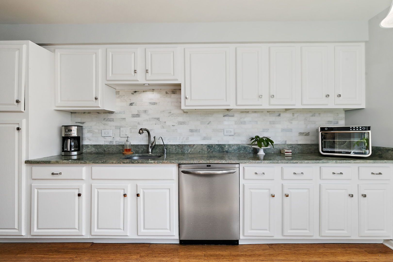 260 Timber Ridge Lane, Unit A Lake Barrington, IL 60010 - Photo 10 of 34 a kitchen with granite countertop white cabinets and stainless steel appliances
