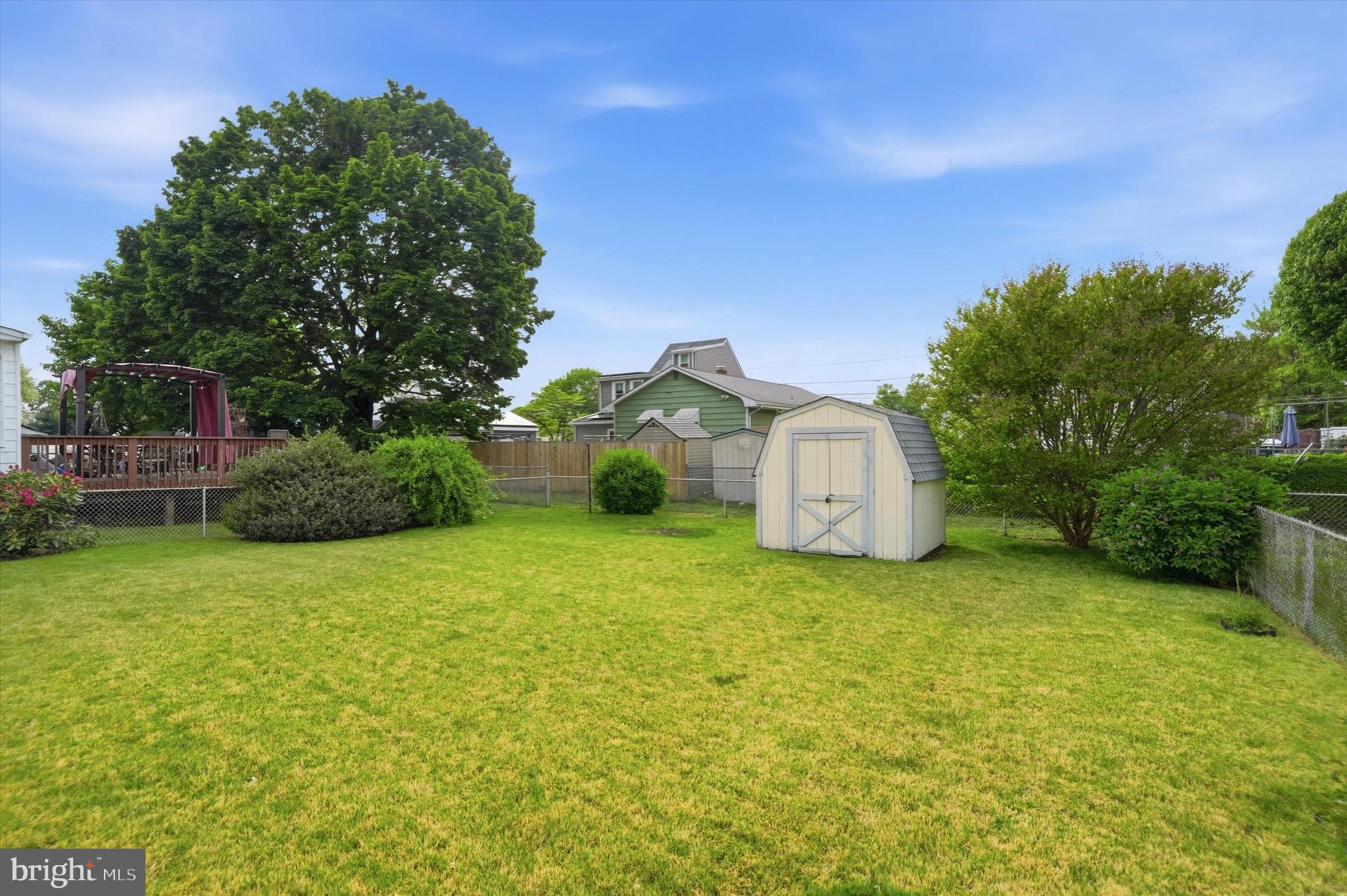100 Wagner Street Hamilton, NJ 08610 - Photo 14 of 15 a yellow house with a big yard and large trees