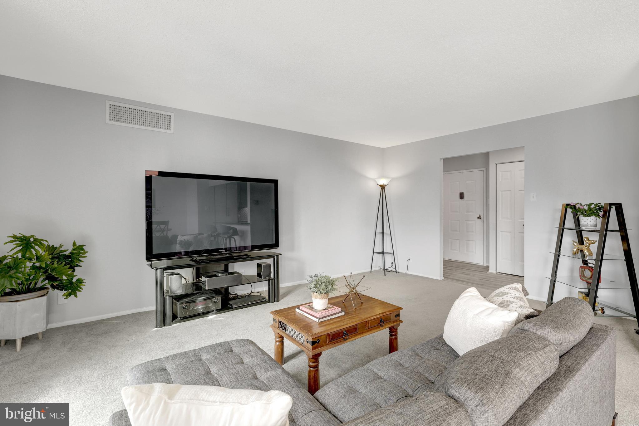 6800 Fleetwood Road, Unit 810 McLean, VA 22101 - Photo 14 of 30 a living room with furniture and a flat screen tv