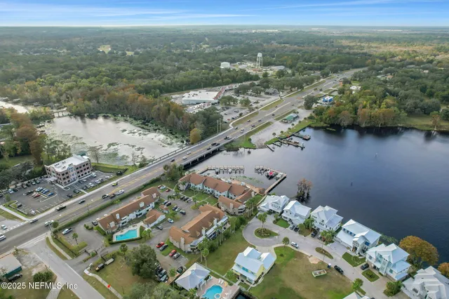an aerial view of a house with a lake view