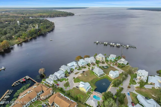 an aerial view of a house with outdoor space and lake view