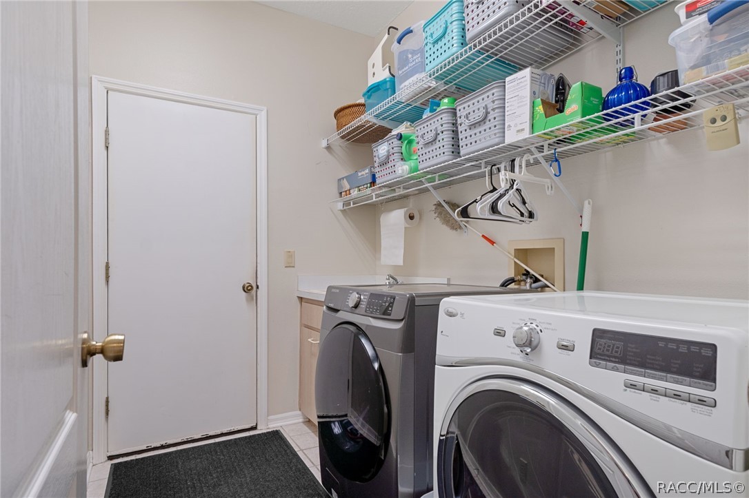 2460 West Pine Ridge Boulevard Beverly Hills, FL 34465 - Photo 35 of 47 a utility room with dryer and washer