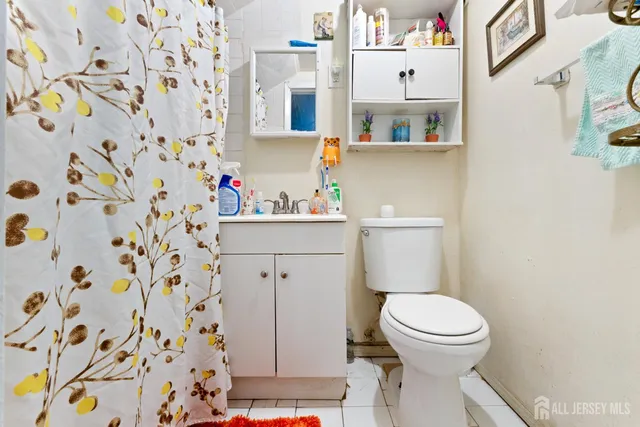 a white toilet sitting next to a bathroom sink