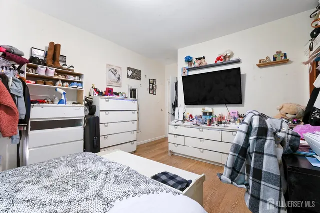 a bedroom with a bed and flat screen tv