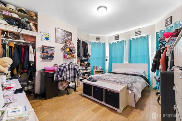 a bedroom with bed and a large mirror
