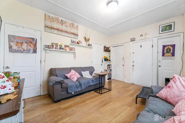 a living room with furniture and a baby crib