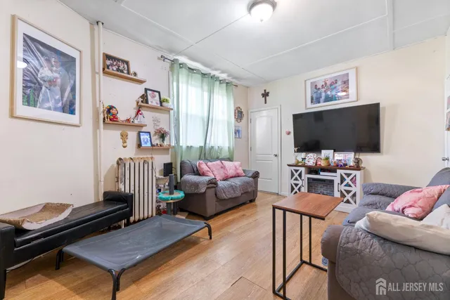 a bedroom with furniture and a flat screen tv