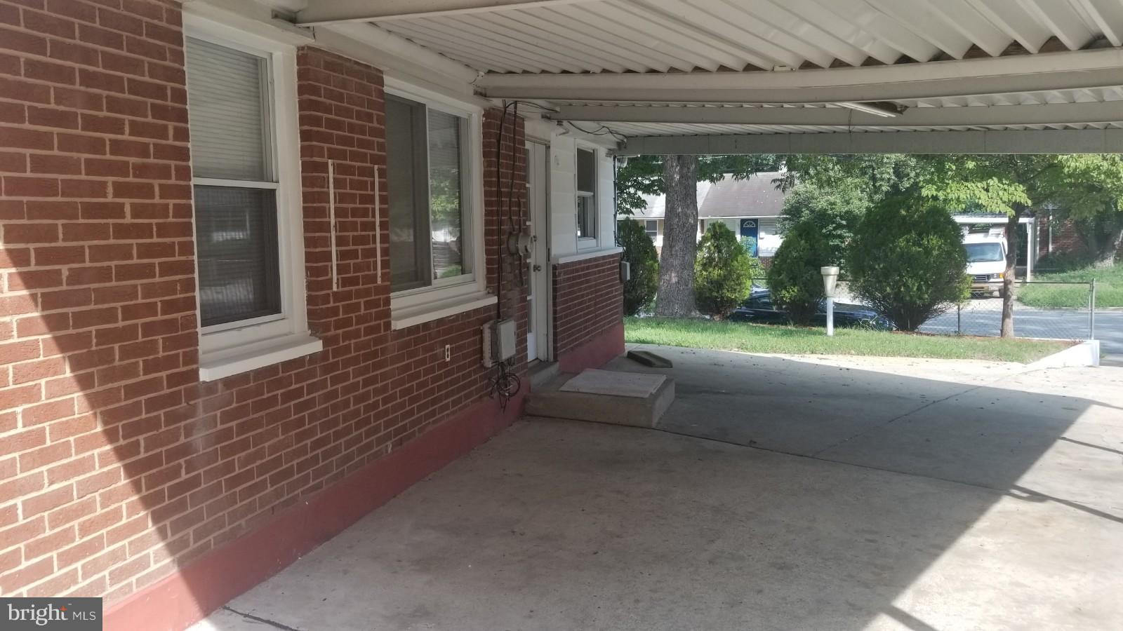 7828 Burnside Road Landover, MD 20785 - Photo 6 of 12 a view of a porch with a floor to ceiling window and yard