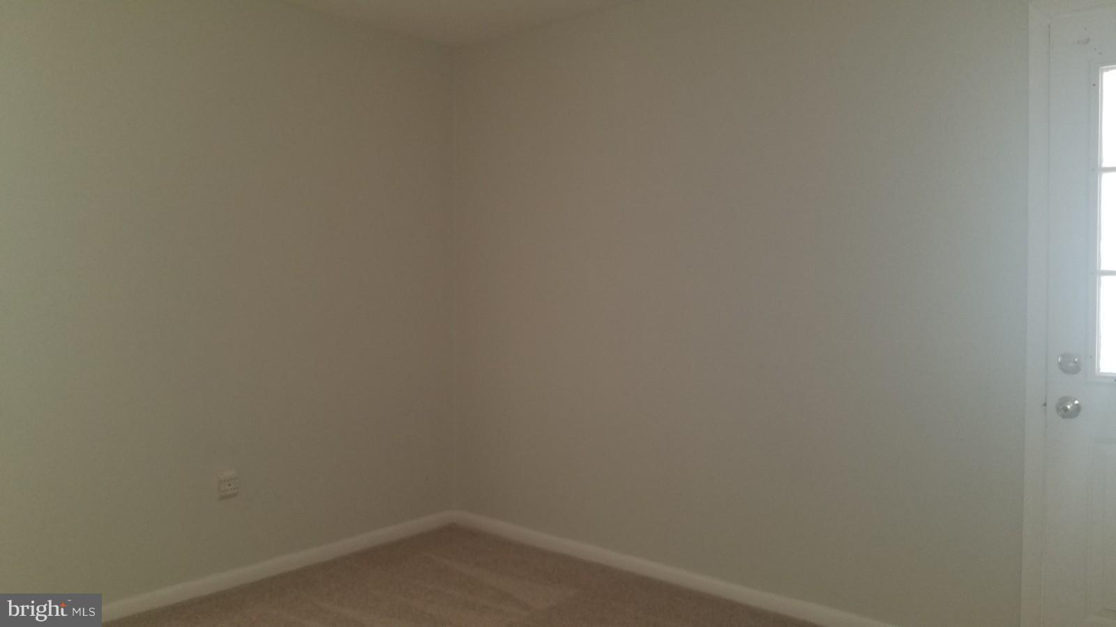 7828 Burnside Road Landover, MD 20785 - Photo 10 of 12 a room that has a white wall