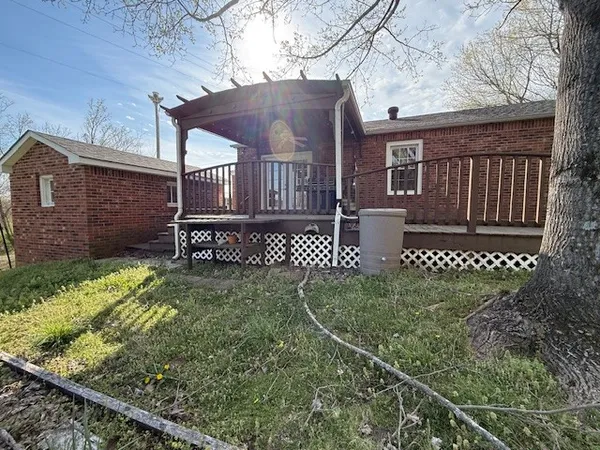 a view of a wooden house with a yard